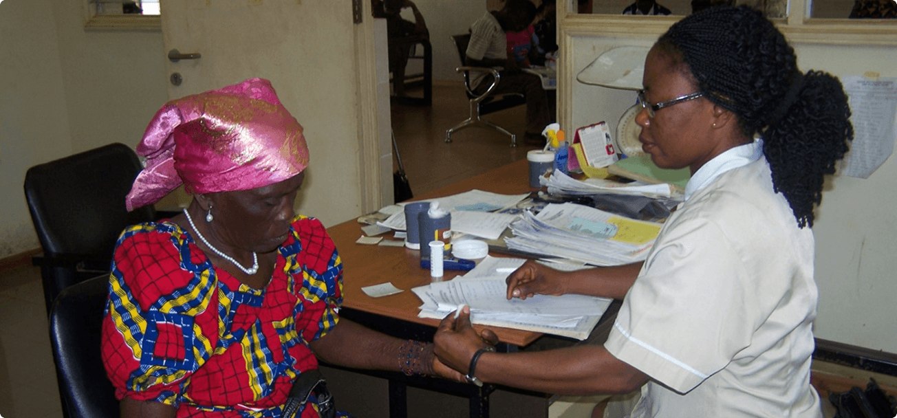 Laboratory technician serving a patient at Iwollo